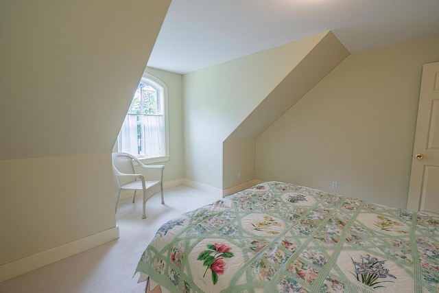bedroom featuring vaulted ceiling, carpet floors, and baseboards