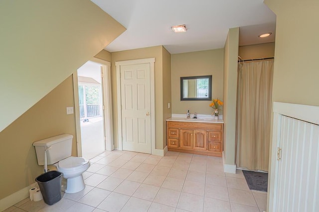 full bath with toilet, tile patterned flooring, vanity, and a healthy amount of sunlight