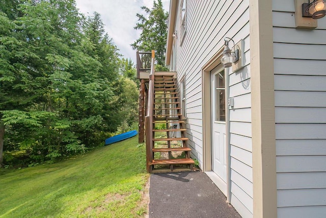 exterior space featuring stairs and a lawn