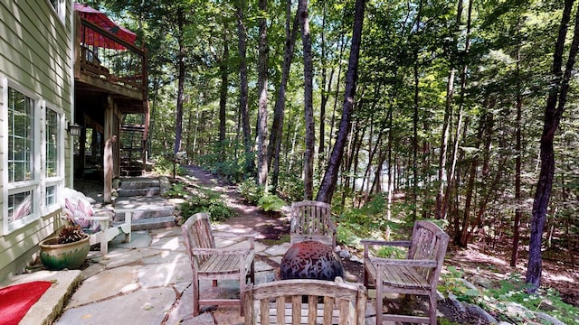 view of patio featuring stairway and a fire pit