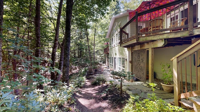 view of side of home with a balcony