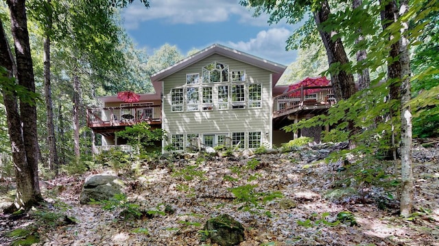 back of property featuring a deck