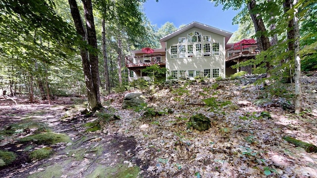 rear view of property with a wooden deck