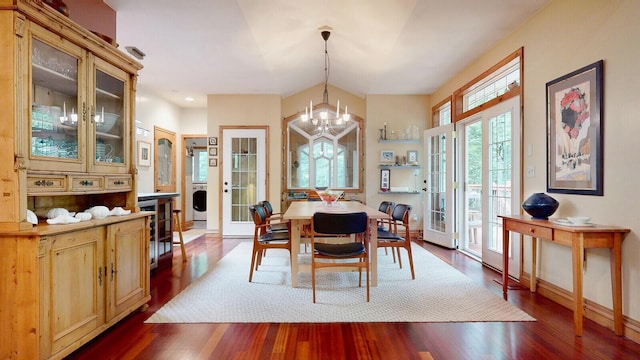 dining room with baseboards, french doors, dark wood-style floors, washer / dryer, and an inviting chandelier