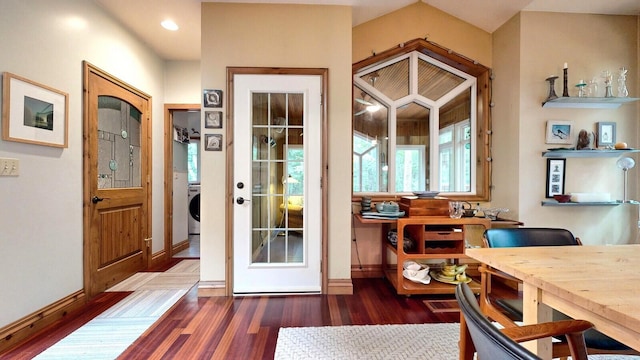 entryway with dark wood-type flooring, washer / clothes dryer, visible vents, and baseboards