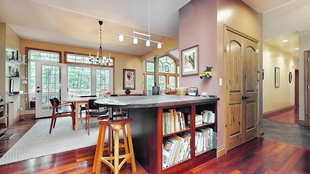 dining area featuring dark wood-type flooring, recessed lighting, baseboards, and an inviting chandelier