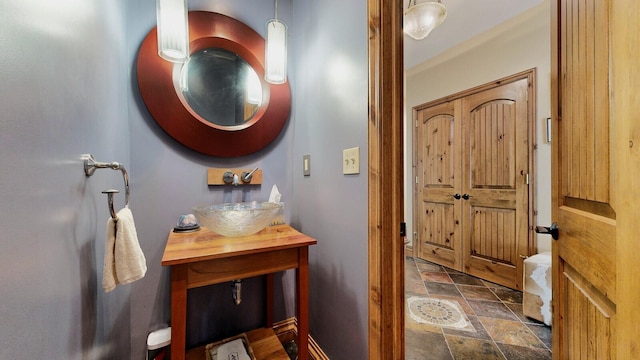 bathroom featuring stone finish floor and vanity