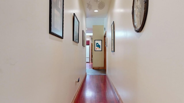 corridor with dark wood-type flooring, recessed lighting, and baseboards