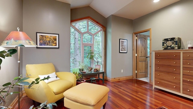 sitting room with lofted ceiling, baseboards, and dark wood-type flooring