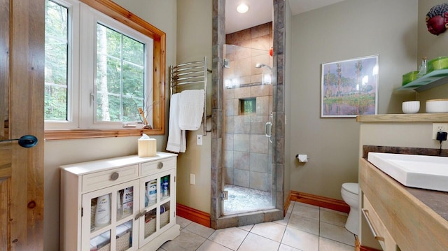 full bath with tile patterned flooring, toilet, vanity, baseboards, and a shower stall