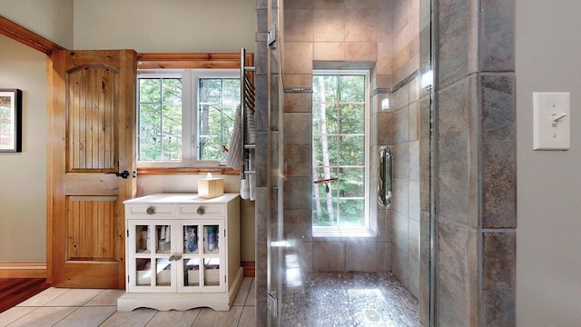 doorway to outside with light tile patterned flooring and a wealth of natural light