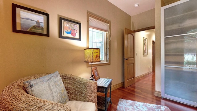 sitting room featuring dark wood finished floors and baseboards