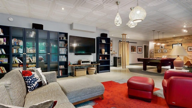 living room with billiards and wood walls