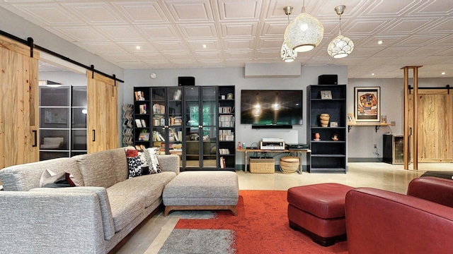 living area with a barn door and an ornate ceiling