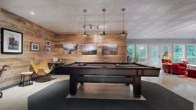 recreation room with wooden walls, french doors, and pool table