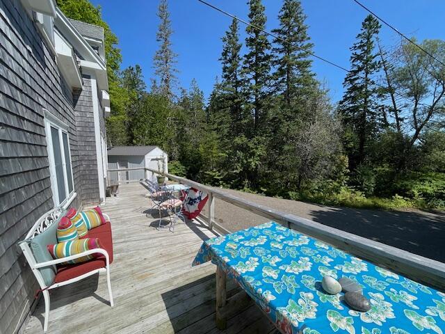 11 Sardine Way, Lubec, ME 04652 - wooden terrace featuring a storage unit and an outbuilding