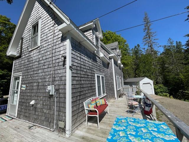 11 Sardine Way, Lubec, ME 04652 - view of side of property featuring an outbuilding and a wooden deck