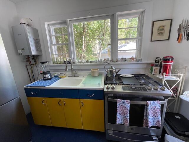 11 Sardine Way, Lubec, ME 04652 - kitchen featuring gas stove, water heater, a sink, and light countertops