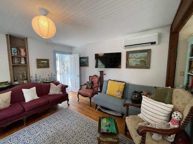 11 Sardine Way, Lubec, ME 04652 - living area featuring wood finished floors and a wall unit AC