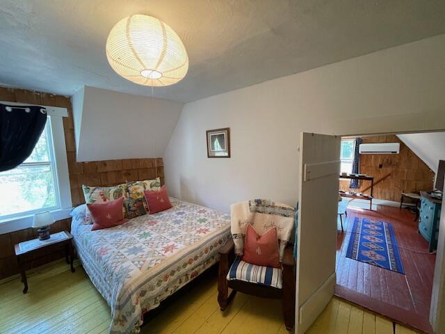 11 Sardine Way, Lubec, ME 04652 - bedroom with light wood-style floors, multiple windows, and a wall unit AC