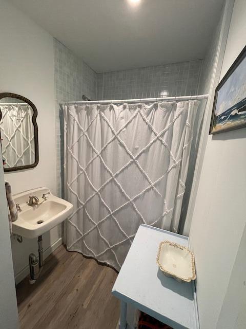 11 Sardine Way, Lubec, ME 04652 - full bathroom with a shower with shower curtain, a sink, and wood finished floors