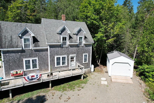 11 Sardine Way, Lubec, ME 04652 - view of front of house featuring a storage shed, a wooden deck, a chimney, and an outbuilding