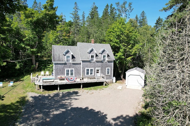 11 Sardine Way, Lubec, ME 04652 - new england style home with driveway, a chimney, a wooden deck, an outdoor structure, and a shed