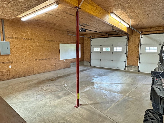 garage with electric panel and a garage door opener