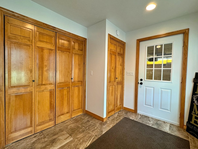 doorway to outside featuring baseboards