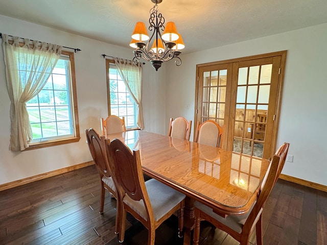 dining space featuring a healthy amount of sunlight, baseboards, a chandelier, and dark wood-type flooring