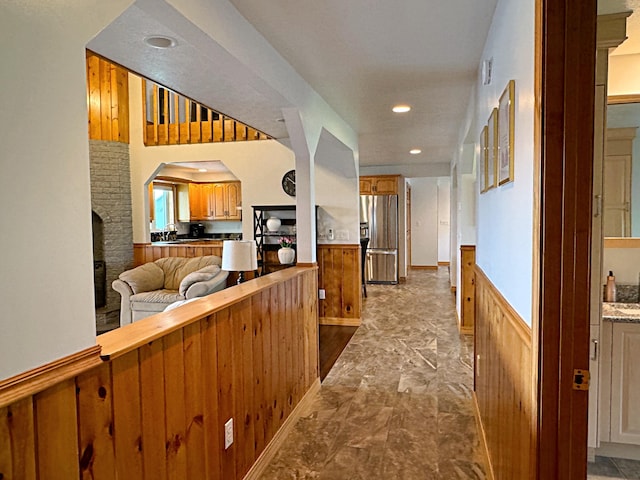 hall with visible vents, a sink, and recessed lighting