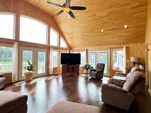 living area with wood walls, wood ceiling, a wealth of natural light, and wood finished floors