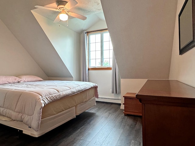 bedroom featuring a baseboard heating unit, lofted ceiling, dark wood-style flooring, and ceiling fan