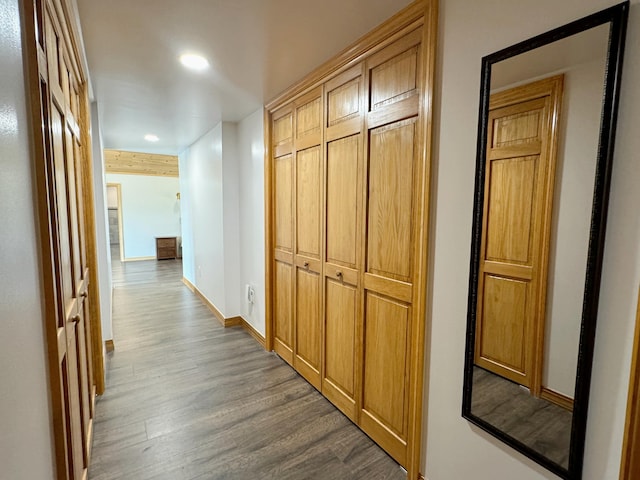 corridor with recessed lighting, dark wood finished floors, and baseboards