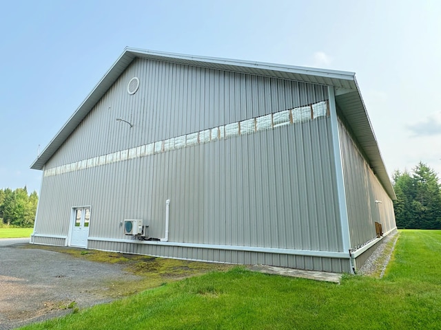 view of property exterior featuring an outbuilding and a lawn