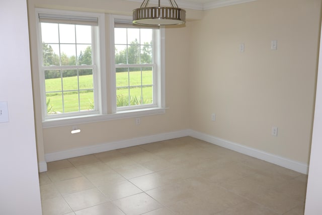 tiled empty room featuring crown molding