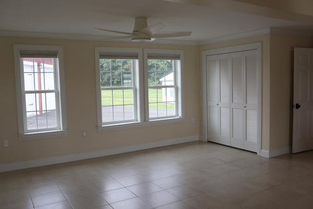 interior space with ceiling fan, plenty of natural light, light tile patterned floors, and crown molding