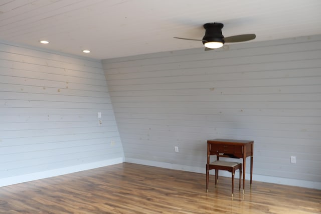 living area with ceiling fan and dark wood-type flooring