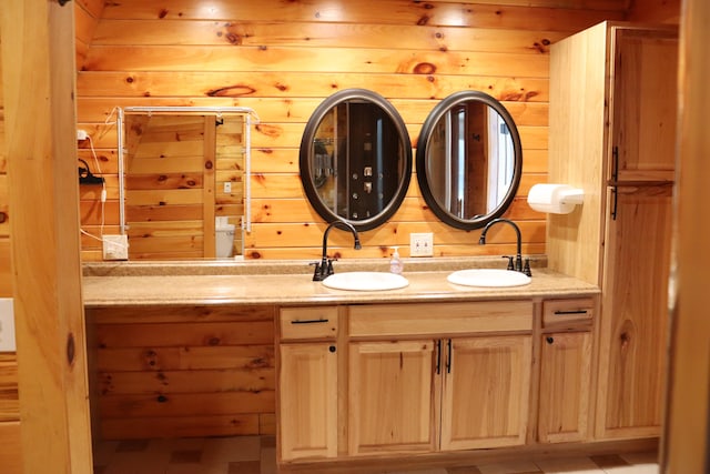 bathroom featuring wood walls and vanity