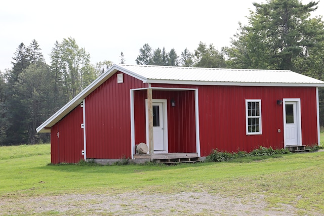 view of outbuilding featuring a lawn