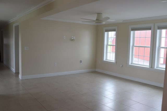 tiled spare room with ornamental molding and ceiling fan