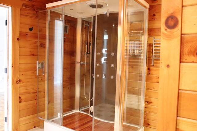 bathroom featuring wooden walls and wood-type flooring