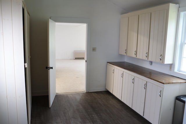 kitchen with white cabinets and dark wood-type flooring