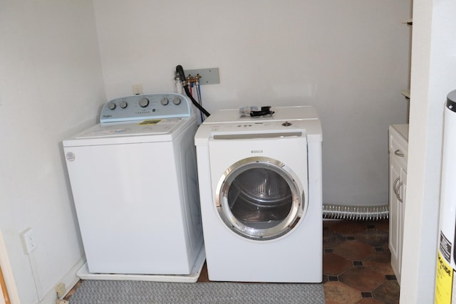 laundry area with cabinets and washing machine and dryer