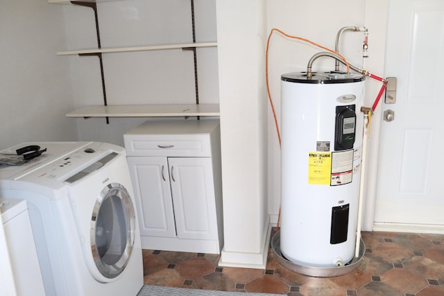 laundry room featuring washer / dryer, electric water heater, and cabinets