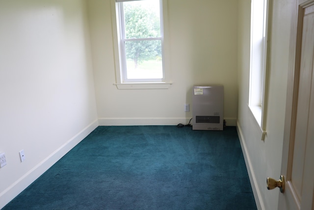 spare room featuring dark carpet