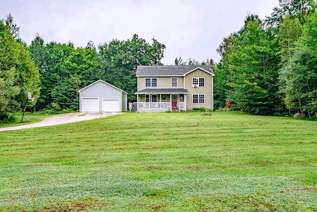 view of front of home featuring a garage, a front lawn, an outbuilding, and covered porch