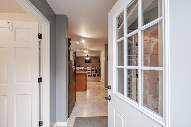 corridor featuring light tile patterned flooring