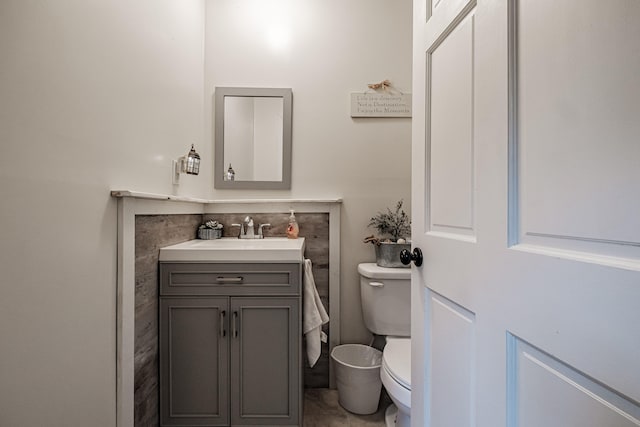 bathroom with tile patterned flooring, toilet, and vanity