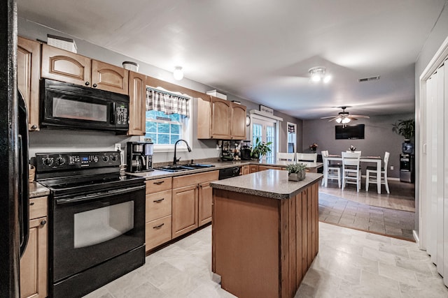 kitchen with sink, black appliances, light tile patterned floors, a center island, and ceiling fan